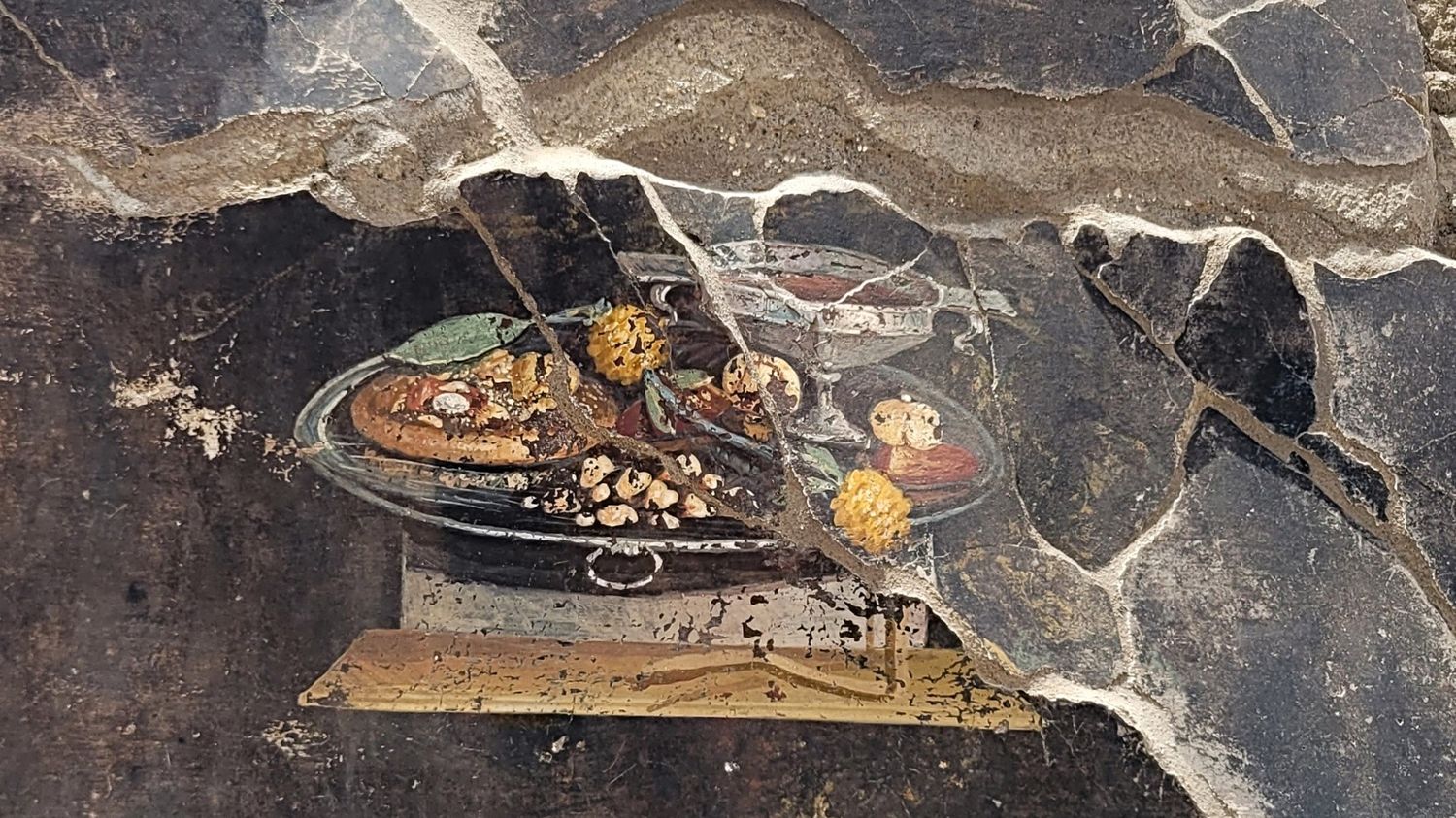 an image of "pizza" discovered on a fresco in the ruins of a Roman city